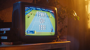 Close Up Footage of a Dated TV Set Screen with Live Sports Tennis Match Broadcast. Two Athletic Female Players in Staged World Cup 1998. Nostalgic Retro Nineties Technology Concept.